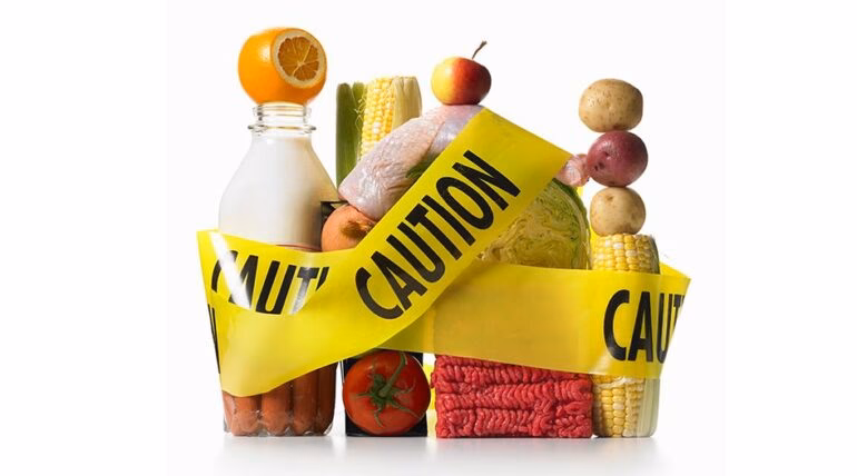 What causes food contamination in a manufacturing facility?